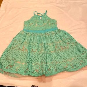 Size 14 Dress worn once. Beautiful mint green color with nude background.